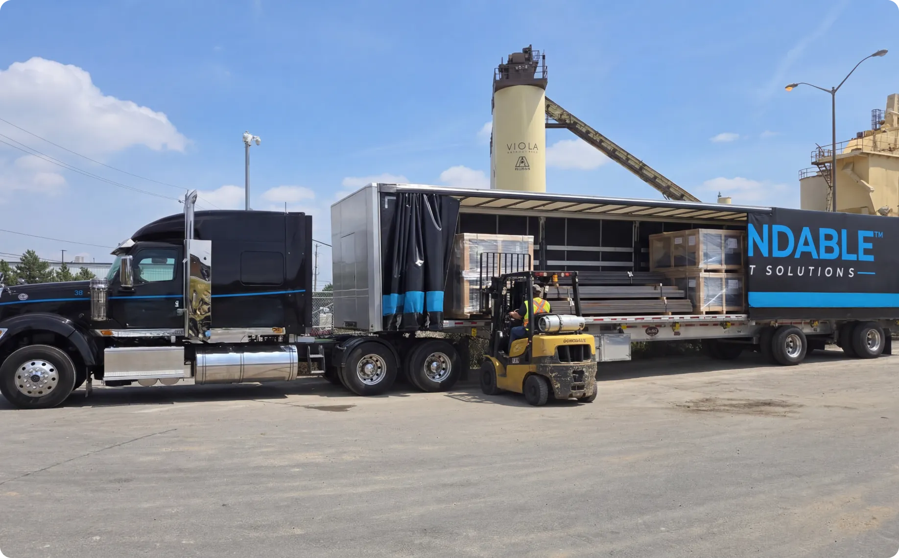 a black freight truck is being loaded